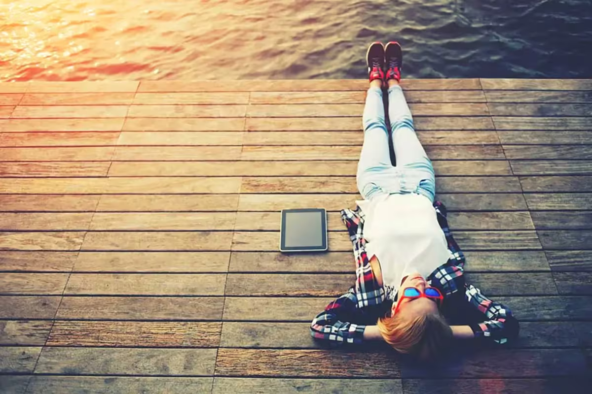 4 Study Habits Adults Can Still Develop Today 3 Man taking a breaking laying down on lake relaxing