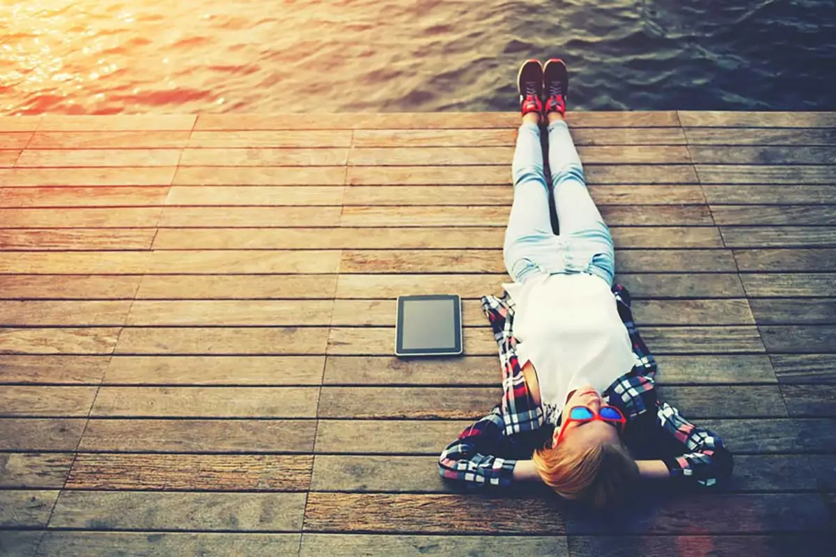 4 Study Habits Adults Can Still Develop Today 3 Man taking a breaking laying down on lake relaxing