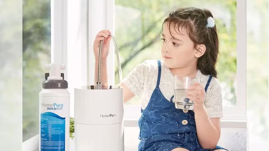 A girl seated, hydrating with HomePure, while reaching for the adjacent HomePure-NovaSoft-Solution-To-Hard-Water