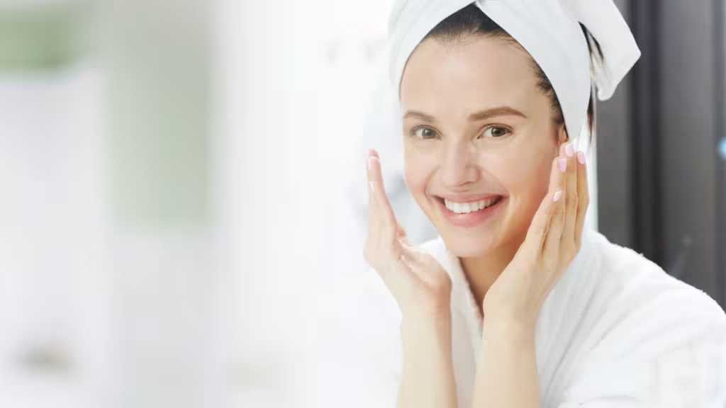 Woman in white robe applying skincare routine from physio radiance