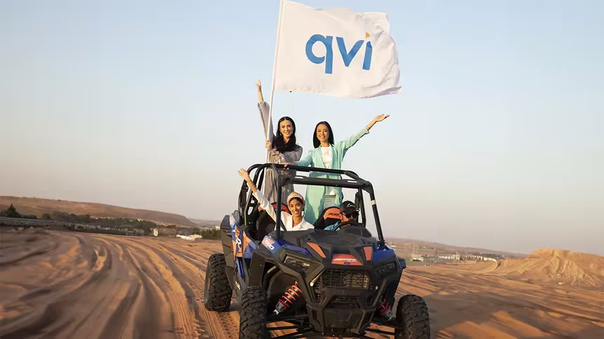 V-Convention Girls on a jeep with a QVI flag, riding in the desert where they enjoyed stress-free travel to for their holiday