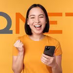 Excited woman holding her phone after a successful QNET Registration