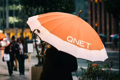 Monsoon Season Tips by QNET - girl with an orange umbrella
