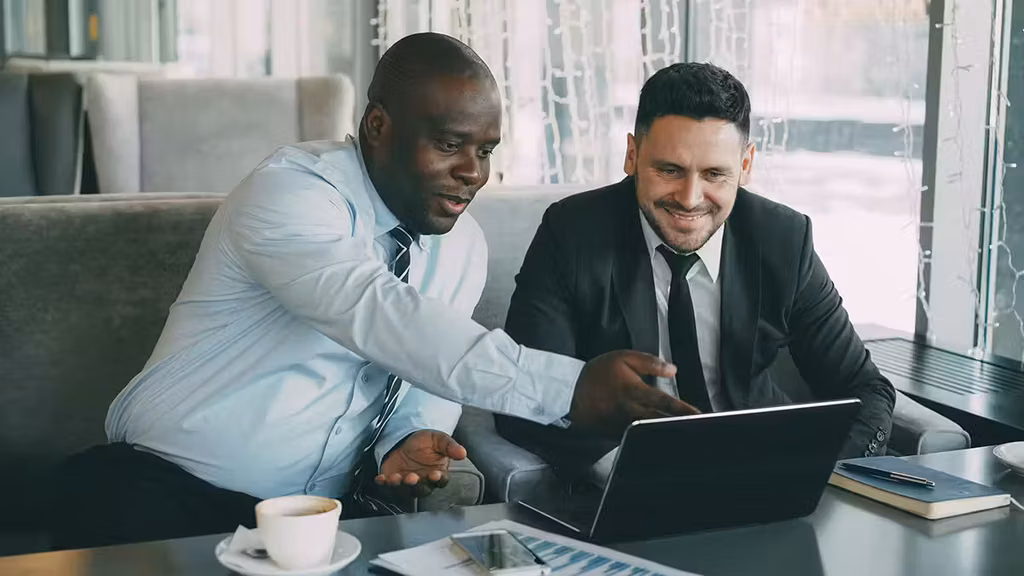 What Teachers Can Teach Us About Becoming Better Leaders 3 Man giving feedback to another man about a project shown on the laptop